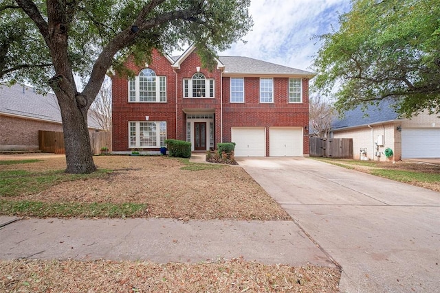 colonial inspired home featuring brick siding, concrete driveway, an attached garage, and fence