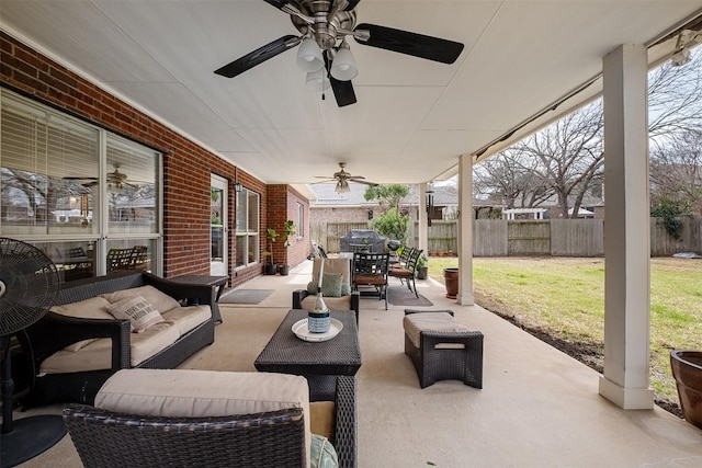 view of patio / terrace featuring an outdoor hangout area, outdoor dining space, a ceiling fan, and fence