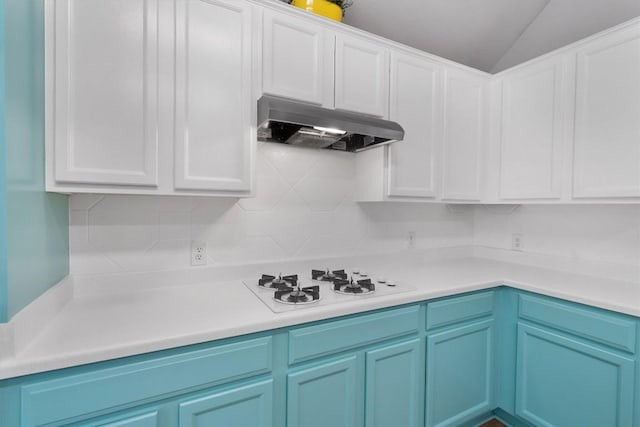 kitchen featuring under cabinet range hood, white cabinetry, light countertops, and white stovetop