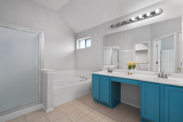 bathroom with a shower stall, a garden tub, double vanity, tile patterned floors, and a sink