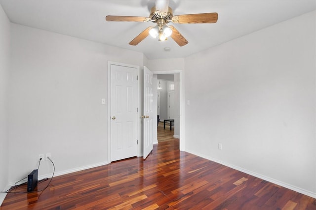 unfurnished room with wood finished floors, baseboards, and ceiling fan