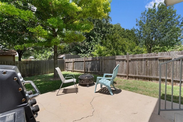 view of patio / terrace featuring area for grilling, an outdoor fire pit, and a fenced backyard