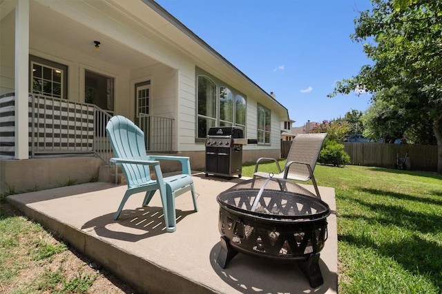 view of patio / terrace featuring fence, area for grilling, and an outdoor fire pit