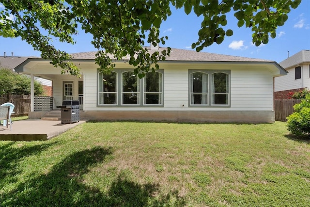 back of property featuring a patio area, a yard, and fence