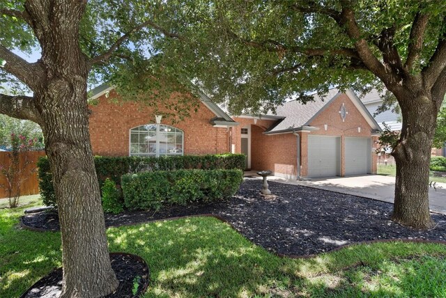 709 Stevenage Dr, Pflugerville, TX 78660 - view of front of home with a garage, brick siding, and concrete driveway