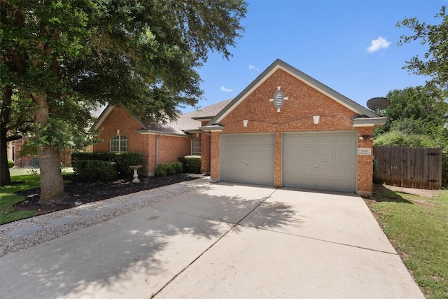 view of front of home with a garage, brick siding, driveway, and fence