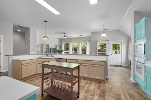 709 Stevenage Dr, Pflugerville, TX 78660 - kitchen with white appliances, light wood finished floors, light countertops, and vaulted ceiling