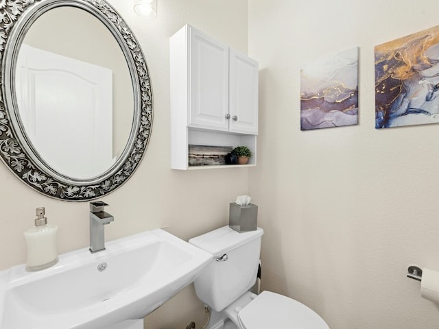 bathroom with toilet and a sink