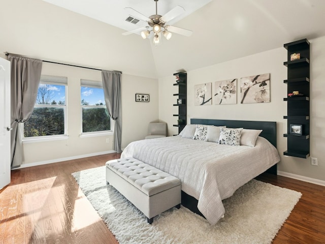 bedroom with a ceiling fan, wood finished floors, visible vents, and baseboards