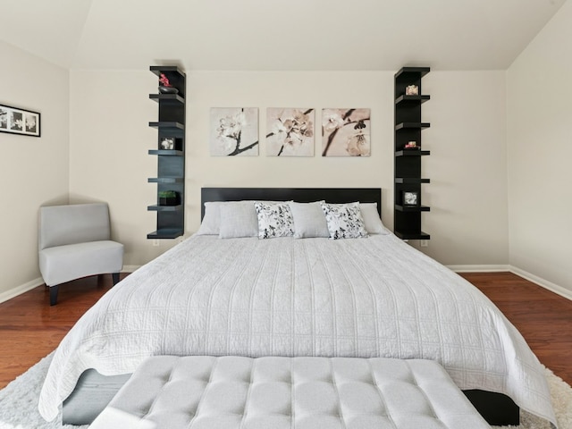 bedroom featuring wood finished floors and baseboards