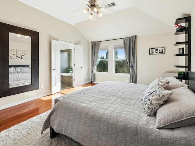 bedroom with a ceiling fan, wood finished floors, visible vents, baseboards, and lofted ceiling