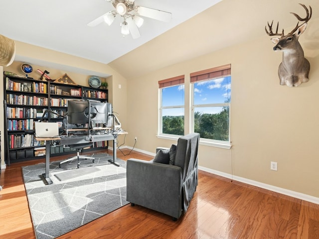 office with vaulted ceiling, a ceiling fan, baseboards, and wood finished floors