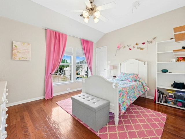 bedroom featuring baseboards, lofted ceiling, wood finished floors, and a ceiling fan