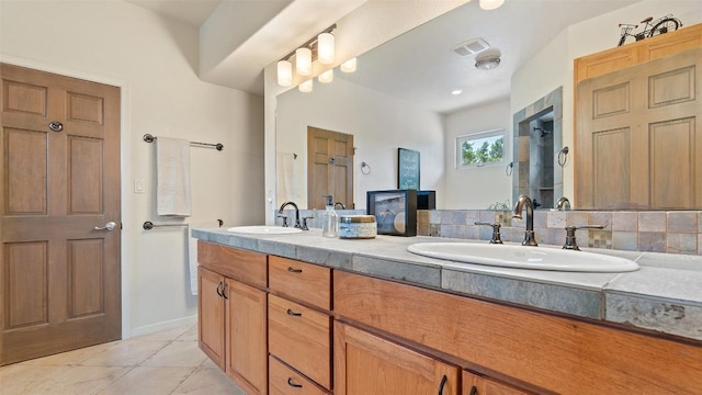 bathroom featuring a sink, visible vents, a shower stall, and tile patterned flooring