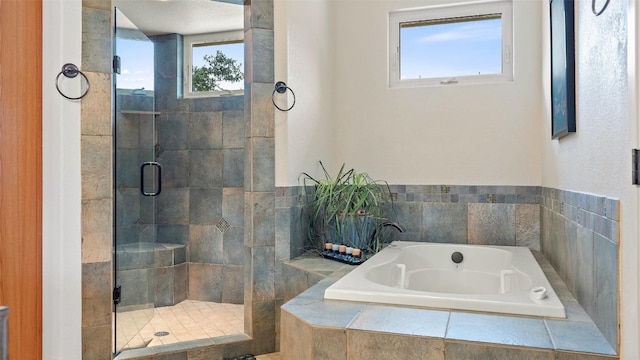 bathroom featuring a bath and a shower stall