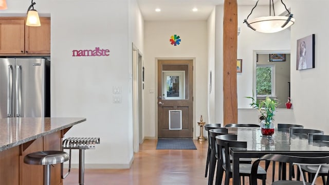 foyer entrance featuring a high ceiling and baseboards