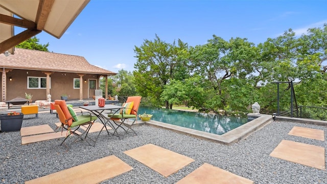 outdoor pool with a patio area and outdoor dining area