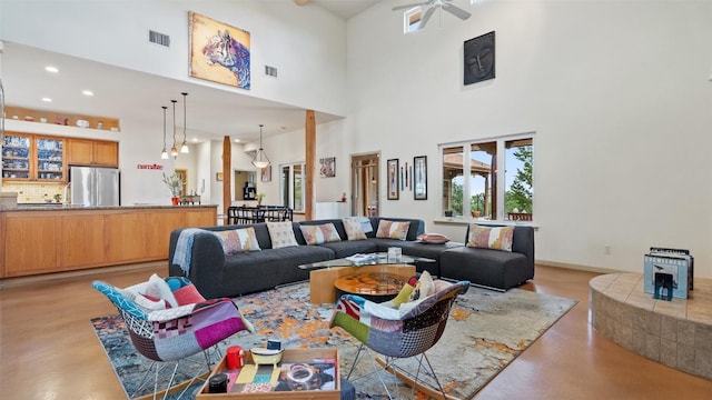 living area with recessed lighting, visible vents, concrete flooring, and a ceiling fan