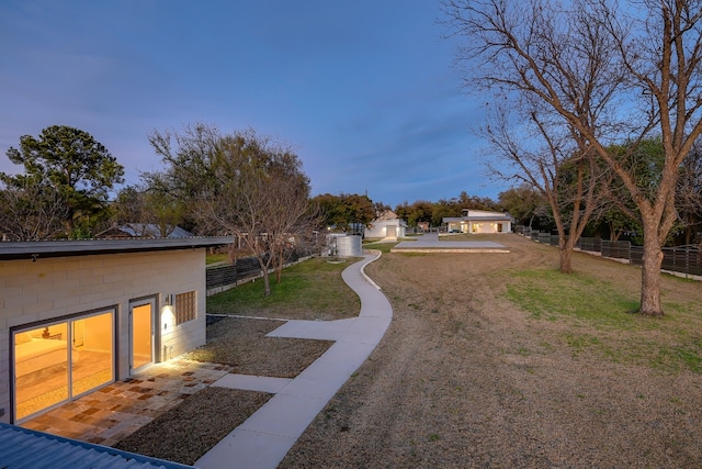 exterior space with an outbuilding, a lawn, and fence