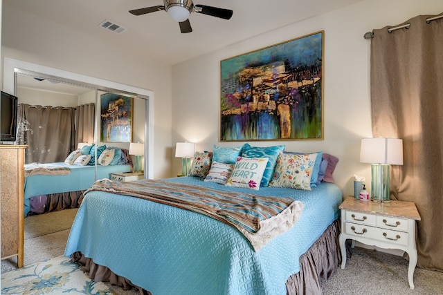 carpeted bedroom with visible vents, a closet, and ceiling fan