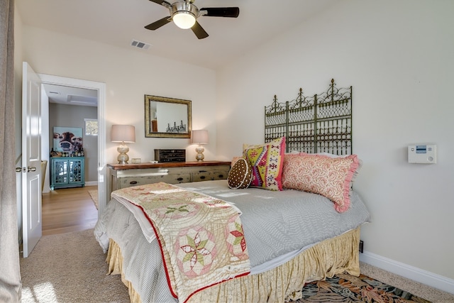 bedroom with baseboards, visible vents, and ceiling fan