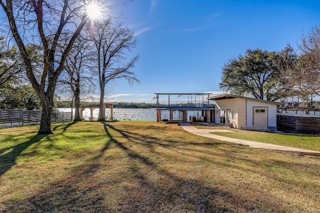 dock area featuring a water view, a yard, and fence