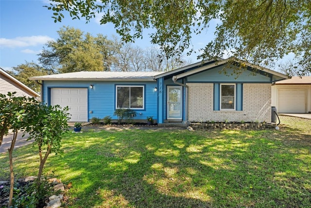 ranch-style house featuring a front lawn, brick siding, and a garage