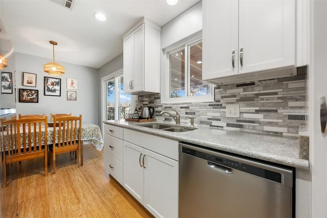 kitchen featuring a sink, white cabinetry, light wood-type flooring, and stainless steel dishwasher