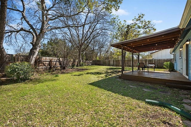 view of yard with a wooden deck and a fenced backyard