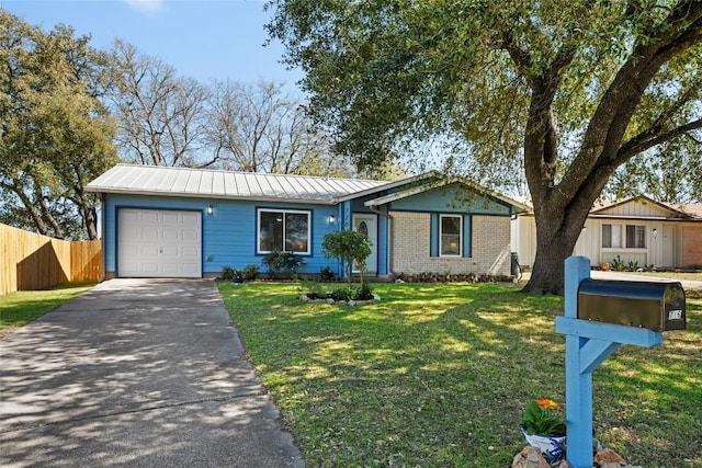 single story home featuring fence, a standing seam roof, an attached garage, aphalt driveway, and brick siding