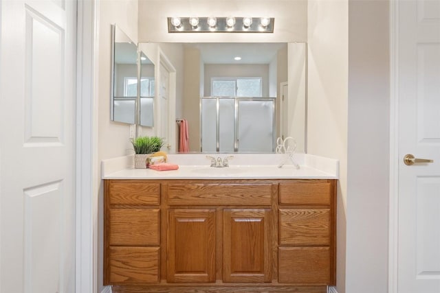 bathroom featuring vanity and a shower stall