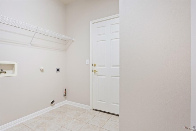 washroom featuring hookup for a gas dryer, light tile patterned floors, hookup for an electric dryer, hookup for a washing machine, and laundry area