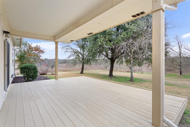 wooden terrace featuring a lawn