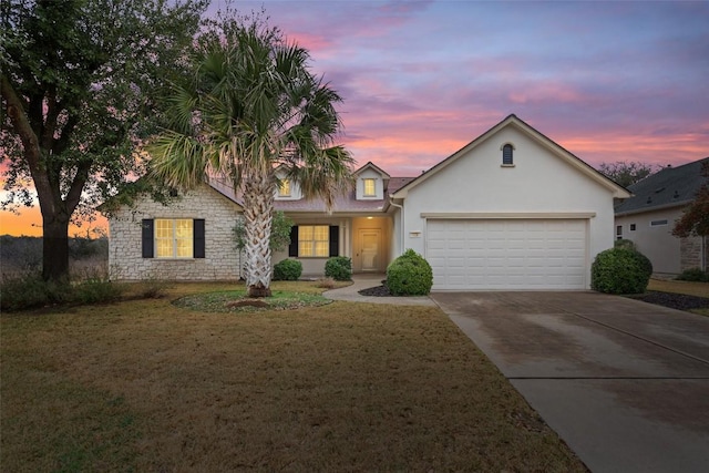721 Texas Dr, Georgetown, TX 78633 - traditional home with an attached garage, concrete driveway, a front lawn, stucco siding, and stone siding