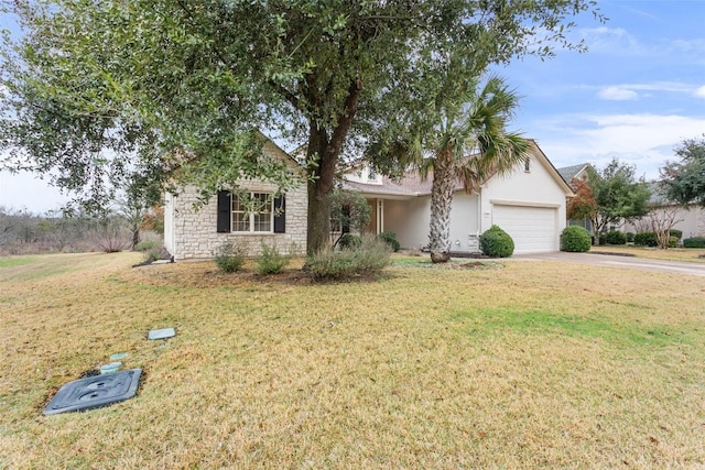 view of front of home with stucco siding, driveway, a front lawn, stone siding, and an attached garage