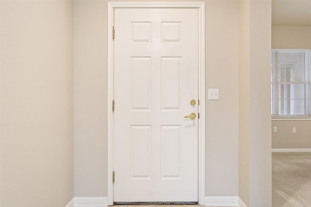 interior space featuring baseboards and carpet