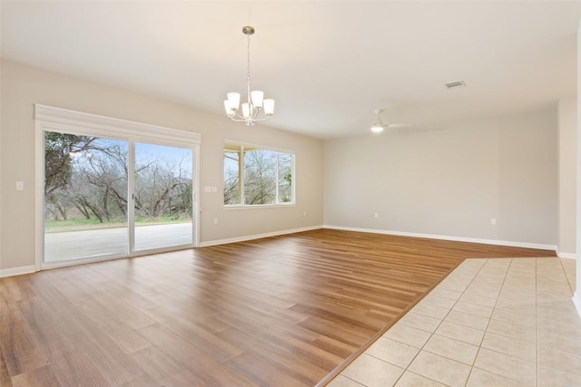 721 Texas Dr, Georgetown, TX 78633 - unfurnished room featuring a chandelier, baseboards, light wood-style flooring, and ceiling fan