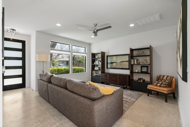 living room featuring ceiling fan, recessed lighting, visible vents, and finished concrete floors