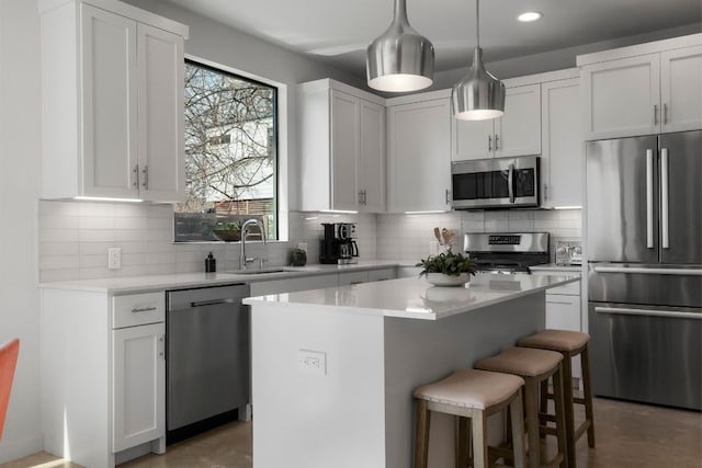 kitchen featuring tasteful backsplash, a kitchen island, a kitchen breakfast bar, and stainless steel appliances