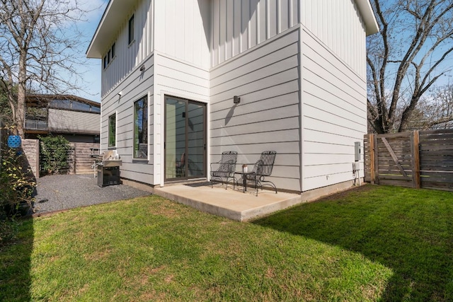 back of house featuring a patio area, a lawn, and a fenced backyard