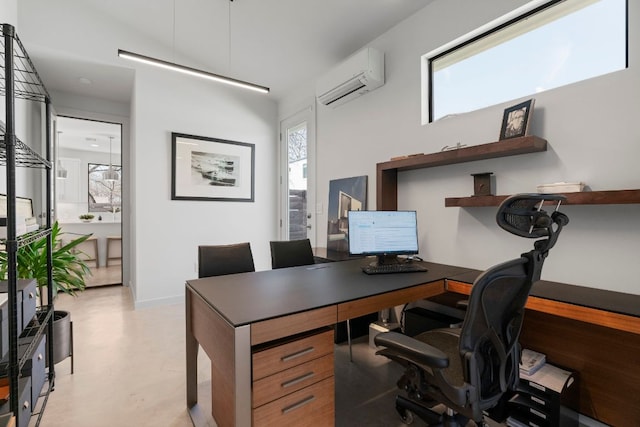 office area featuring baseboards, concrete flooring, and a wall unit AC