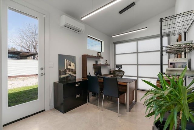 office with a wealth of natural light, finished concrete floors, and a wall mounted AC