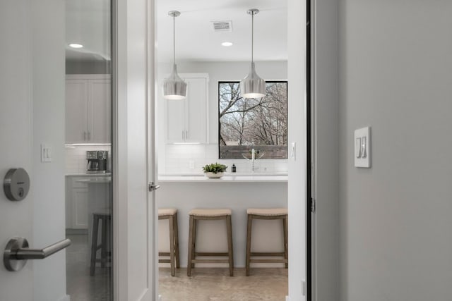 interior space with recessed lighting, visible vents, and backsplash