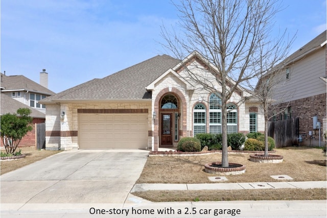 view of front of property featuring stone siding, driveway, and roof with shingles