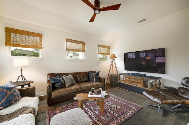 living room with visible vents, baseboards, wood finished floors, and a ceiling fan