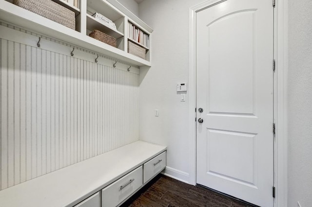 mudroom featuring baseboards and dark wood-style flooring