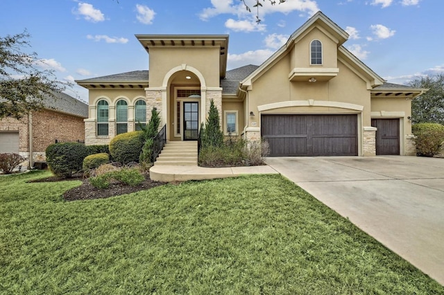 mediterranean / spanish-style house with stone siding, stucco siding, driveway, and a front yard