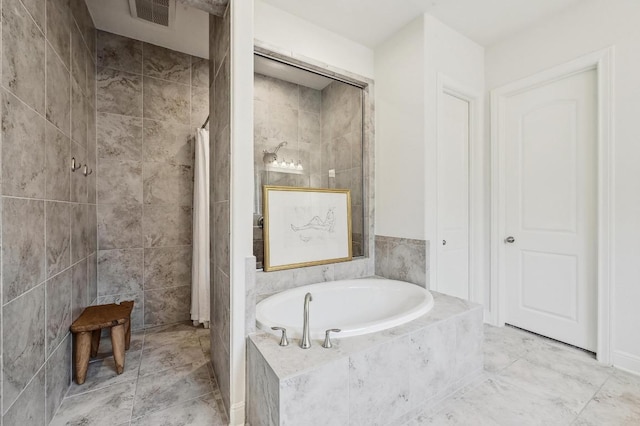 full bathroom with visible vents, tiled shower, and a garden tub