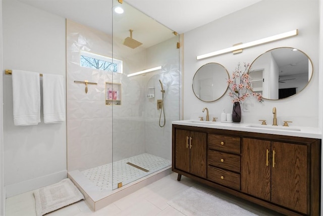 full bathroom featuring double vanity, a walk in shower, and a sink