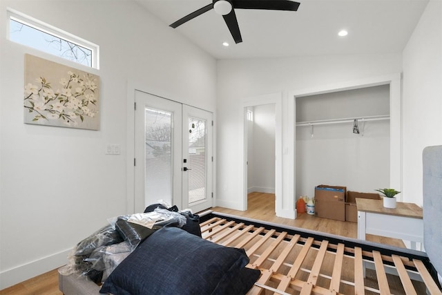 bedroom featuring multiple windows, french doors, lofted ceiling, and wood finished floors